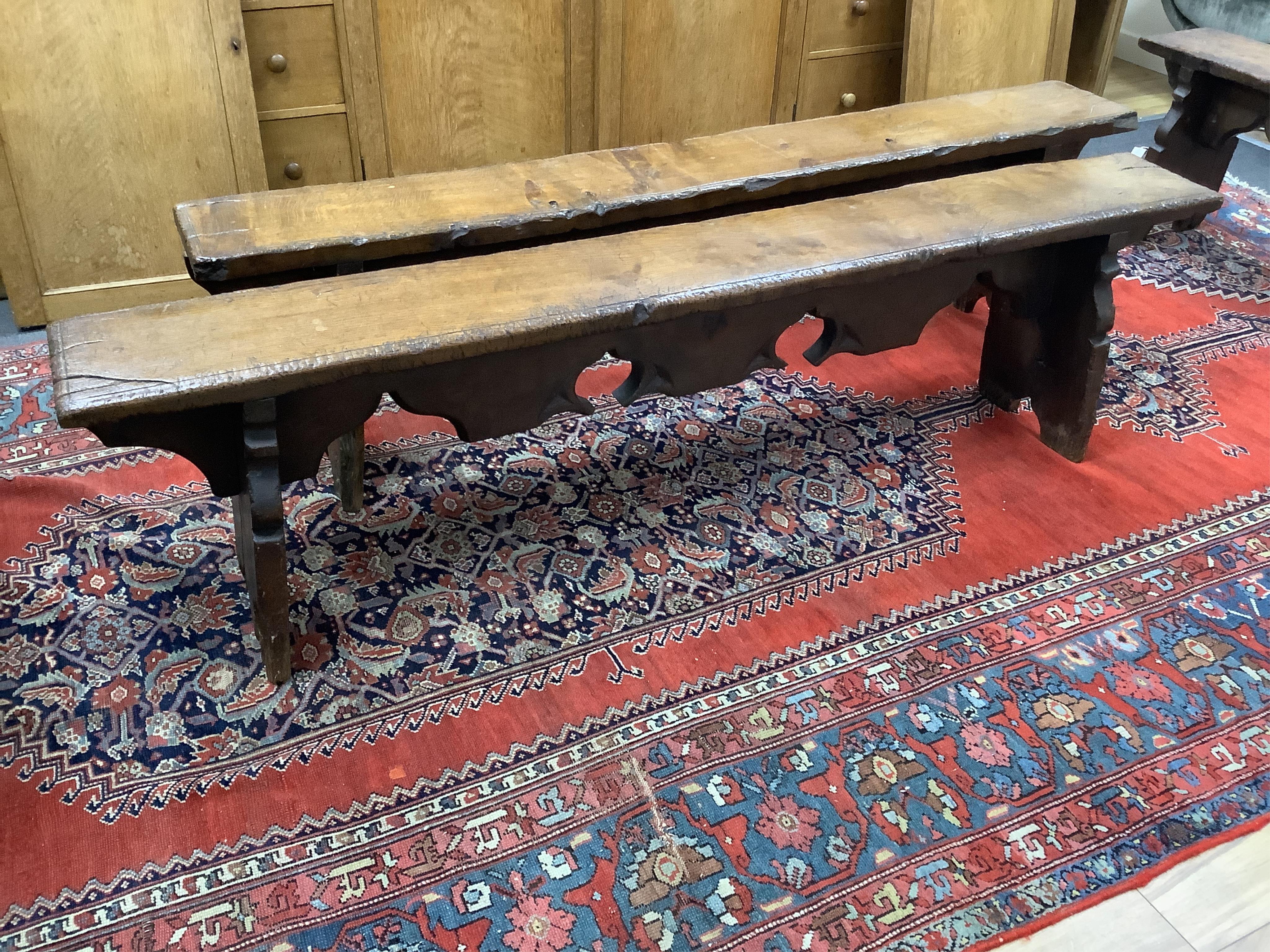 A pair of oak trestle end benches, in Elizabethan style, width 182cm, depth 25cm, height 49cm. Condition - fair, Provenance - made for Brede Place, Brede, Rye, East Sussex. Commissioned from Stuart interiors who have fur